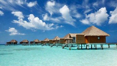 Overwater bungalows in turquoise lagoon
