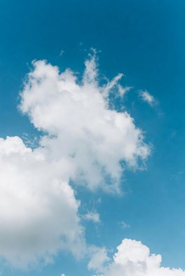Fluffy white clouds in blue sky