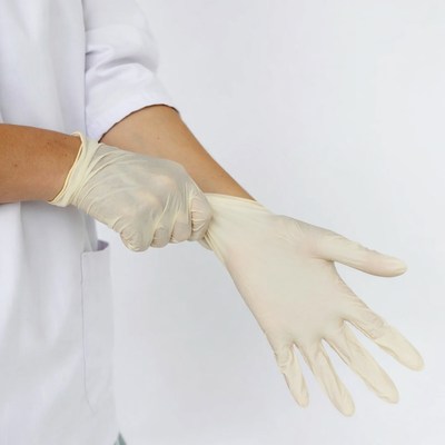Woman putting on latex gloves