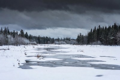 Frozen River in Snowy Forest