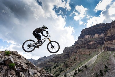 Man jumping mountain bike off cliff