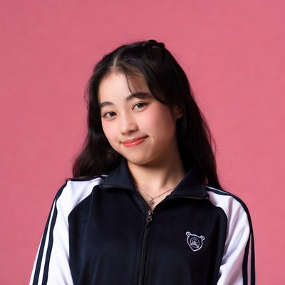 Asian girl in navy tracksuit smiling