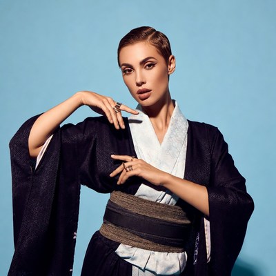 Woman in kimono posing on blue background
