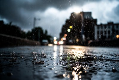 Rainy Street with Blurred Traffic Lights