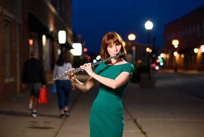 Woman playing flute on night street