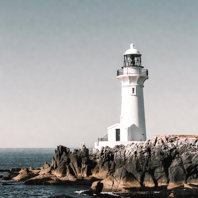 White lighthouse on rocky ocean coast