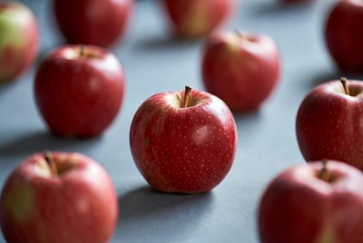 Red apples on blue surface