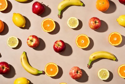 Assortment of Fresh Fruits on Tan Background