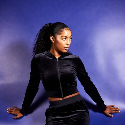 African-American woman in black velvet tracksuit