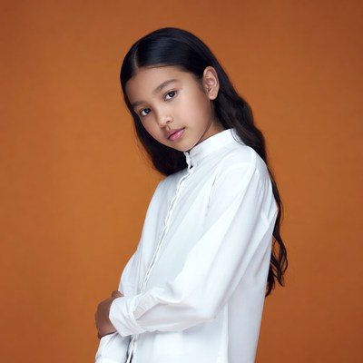 Asian girl in white shirt on orange background
