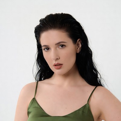 Woman with wet black hair in green slip