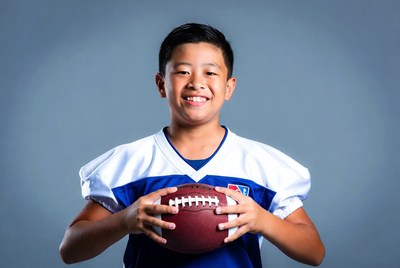 Asian boy holding football