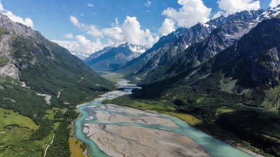 Turquoise River in Snowy Mountain Valley