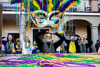 Group celebrating Mardi Gras with beads and masks