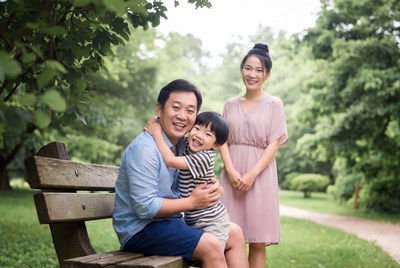 Asian family hugging on park bench