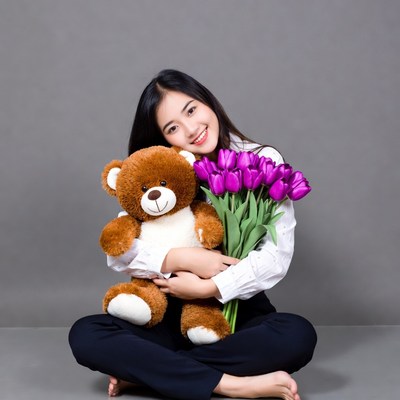 Asian woman hugging teddy bear with tulips
