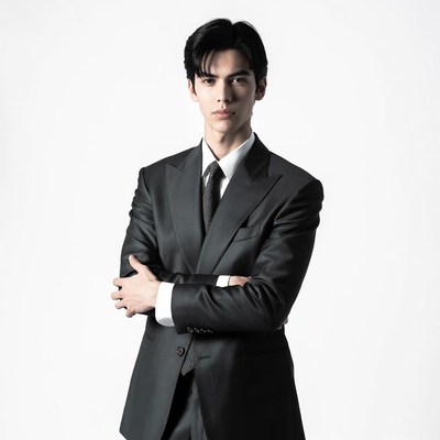 Asian man in suit arms crossed