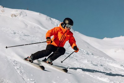 Skier descending snowy mountain slope