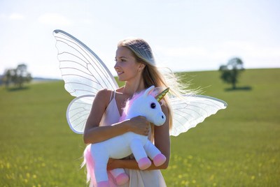 Woman with fairy wings holding unicorn