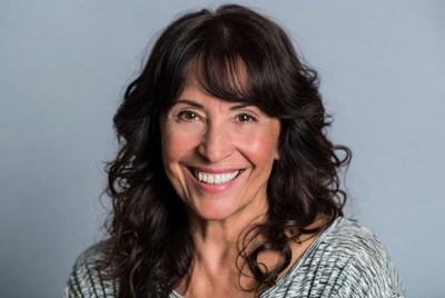 Smiling woman with curly brown hair
