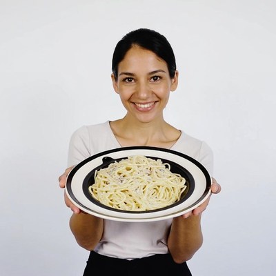 Woman holding spaghetti plate
