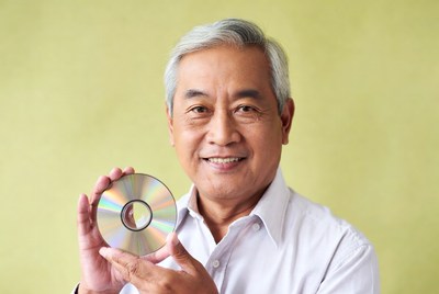 Asian man holding CD