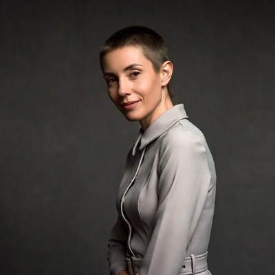 Woman with short hair in gray dress