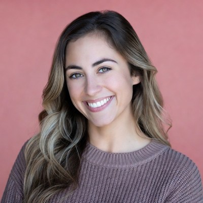 Smiling woman with wavy brown hair