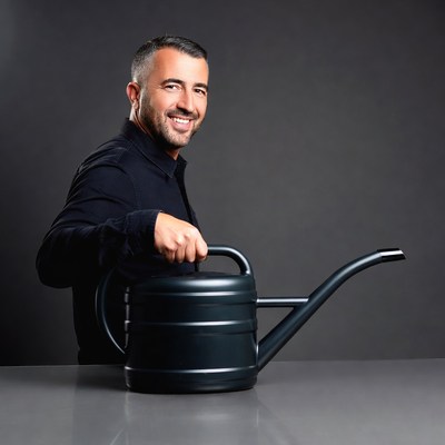 Man holding black watering can