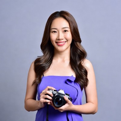 Asian woman holding camera