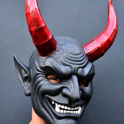 Man wearing demon mask