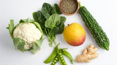 Fresh vegetables and mango on white background
