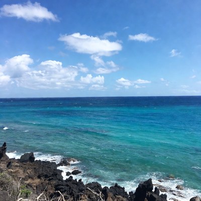 Turquoise Ocean Waves Crashing on Black Rocks