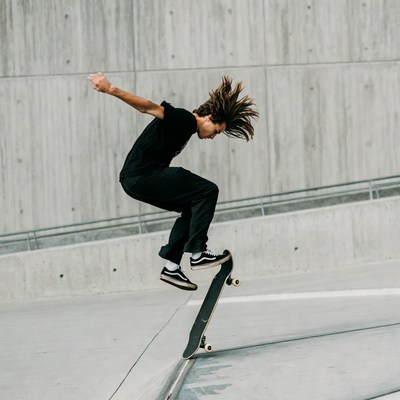Young man skateboarding mid-air jump