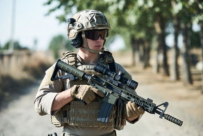 Soldier holding rifle in field