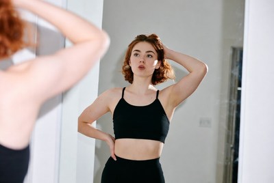 Redhead woman posing in mirror