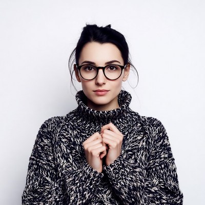 Woman in turtleneck sweater with glasses