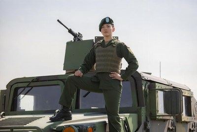 Asian soldier standing on Humvee