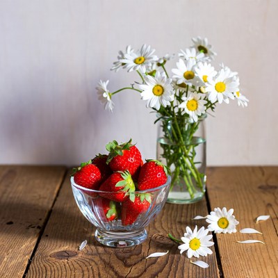 Strawberries and Daisies on Wooden Table