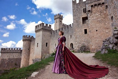 Woman in purple gown at medieval castle