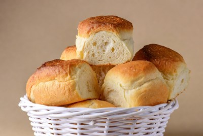 Fresh bread rolls in white basket