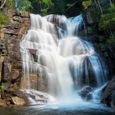Majestic waterfall cascading rocks forest