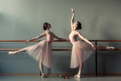 Two ballerinas at ballet barre
