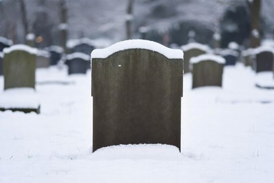 Snowy Grave Stone in Cemetery