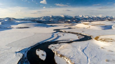 Snowy River Winding Through Winter Mountains