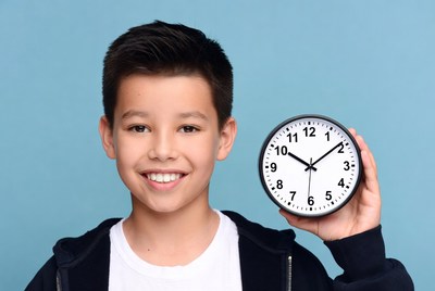 Boy holding clock