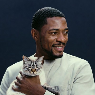 African-American man holding tabby cat