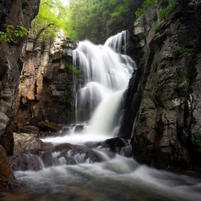 Waterfall cascading between rocky cliffs