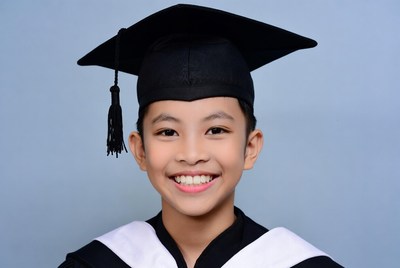 Asian boy in graduation cap and gown