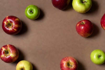 Red and Green Apples on Brown Surface